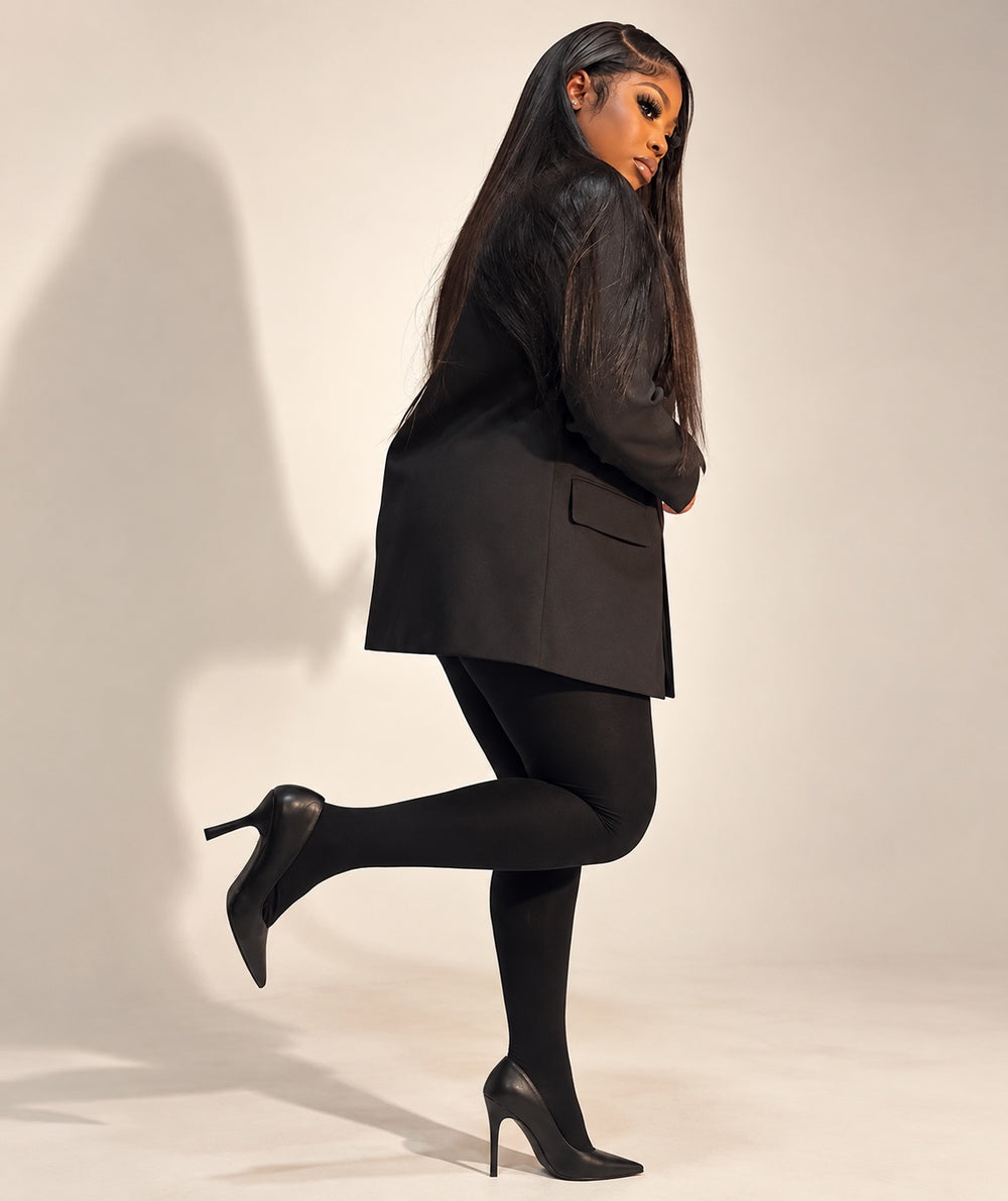 The founder of 247 Luxe Lab wearing a black blazer and heels